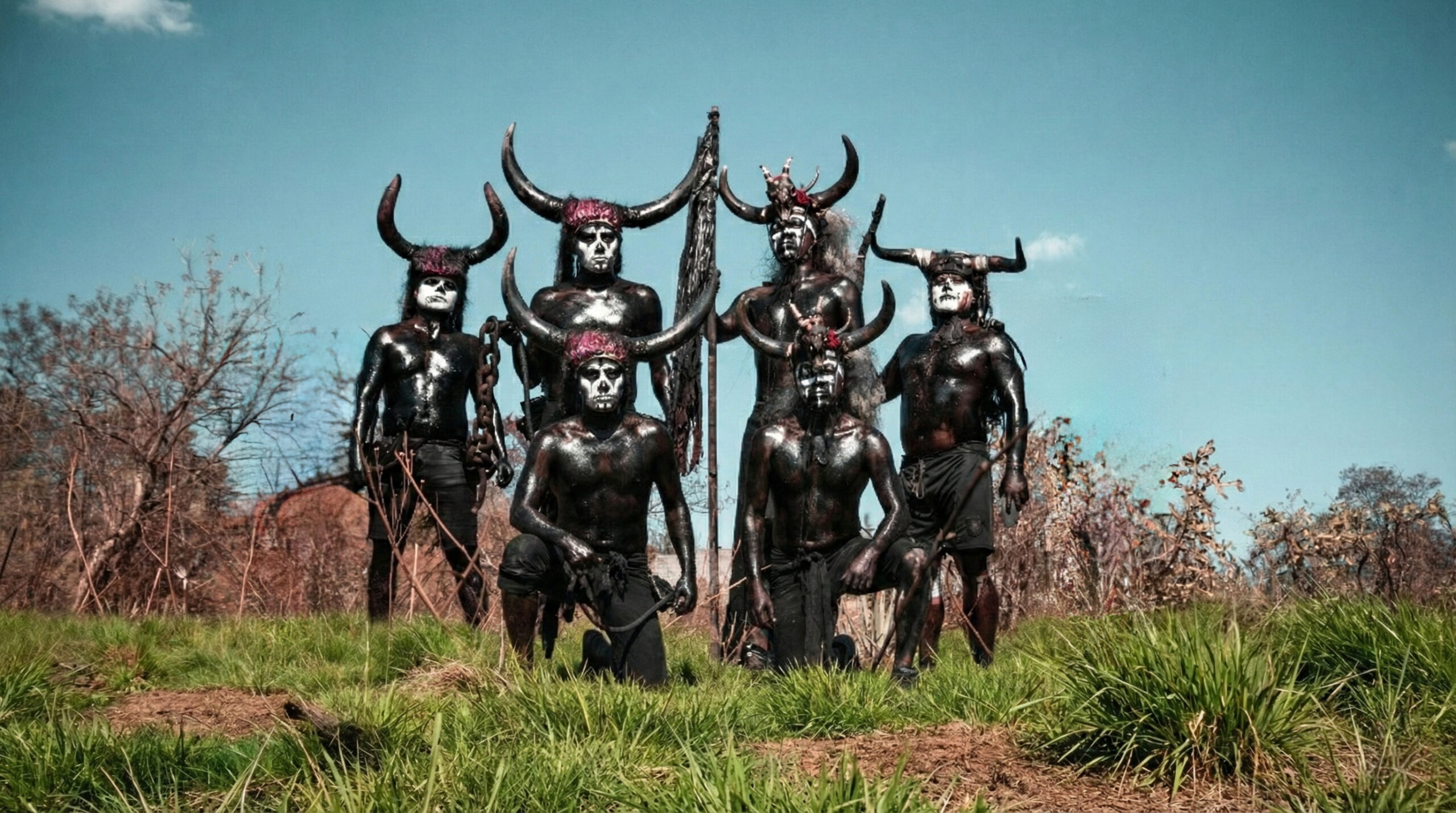 Masked Diablos Aceitados in San Martín Tilcajete during Carnaval in Oaxaca, covered in dark body paint and wearing a carved wooden mask