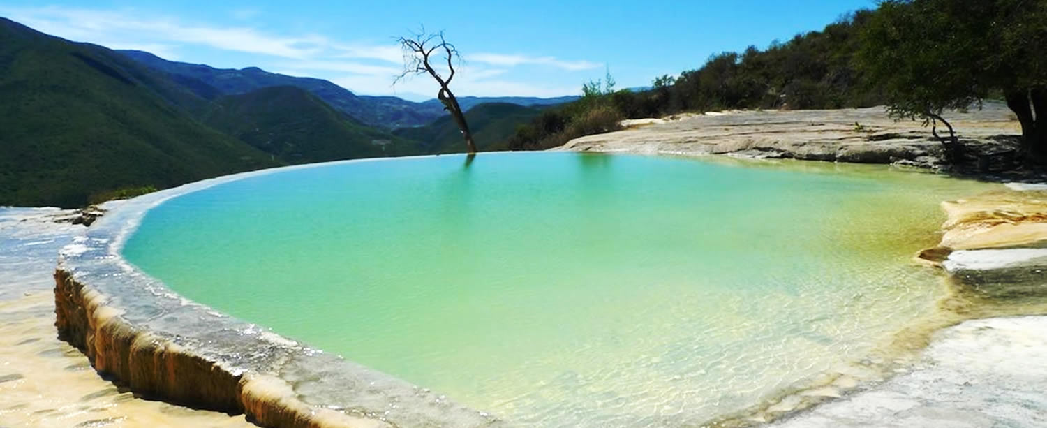 Petrified waterfalls and mineral pools at Hierve el Agua overlooking the Oaxacan mountains